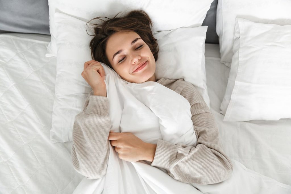 5 Ways to Get More REM Sleep woman sleeping overhead view