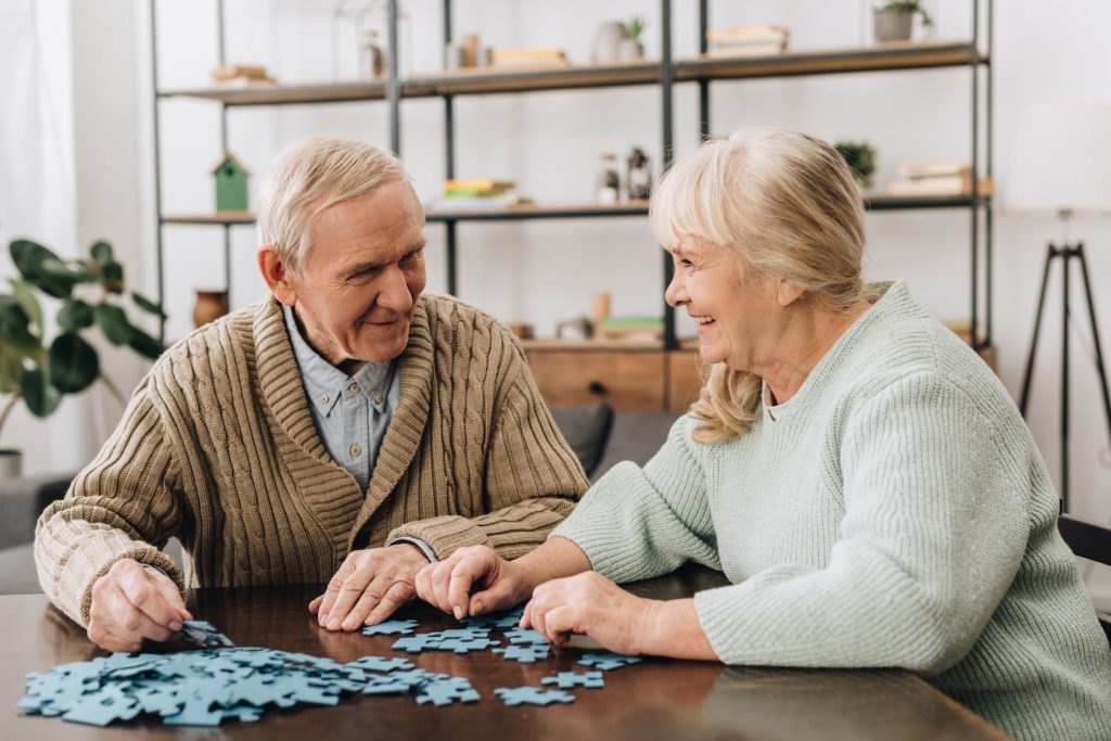 Dementia and Sleep Elderly couple at table working on a puzzle