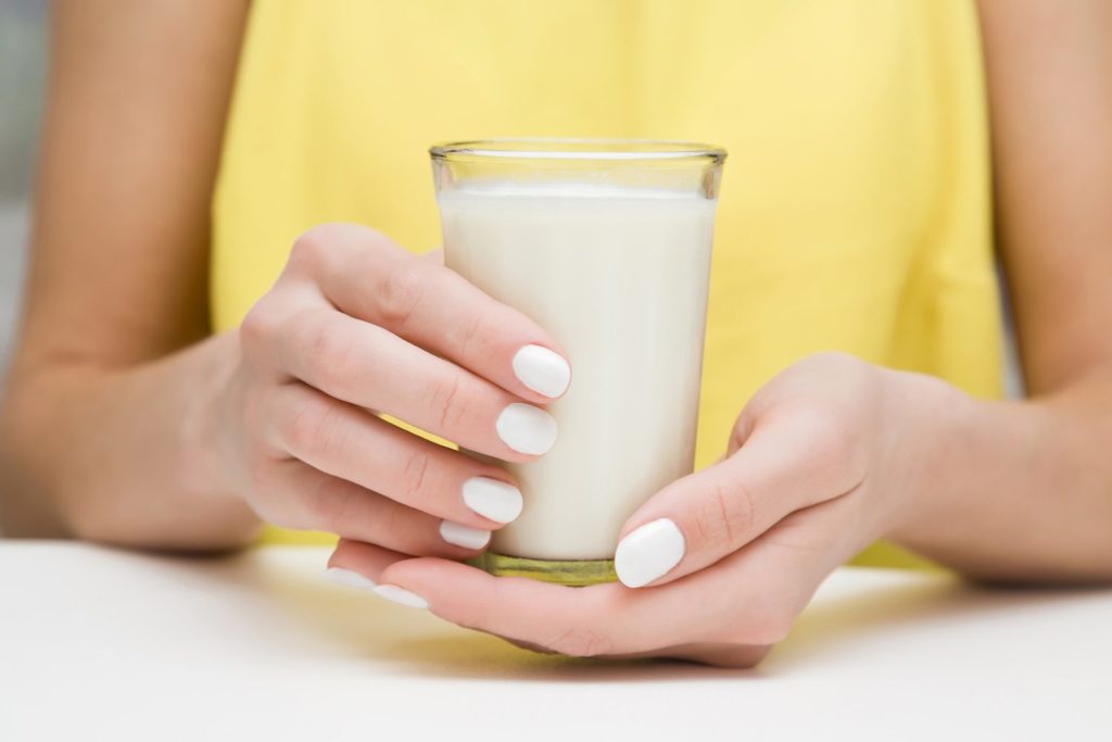 Does Warm Milk Help You Sleep? Woman holding warm milk