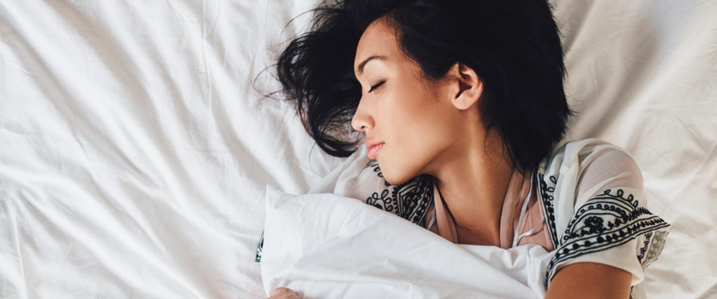 How to Sleep with Lower Back Pain: Finding Comfort and Relief A woman sleeps on her back