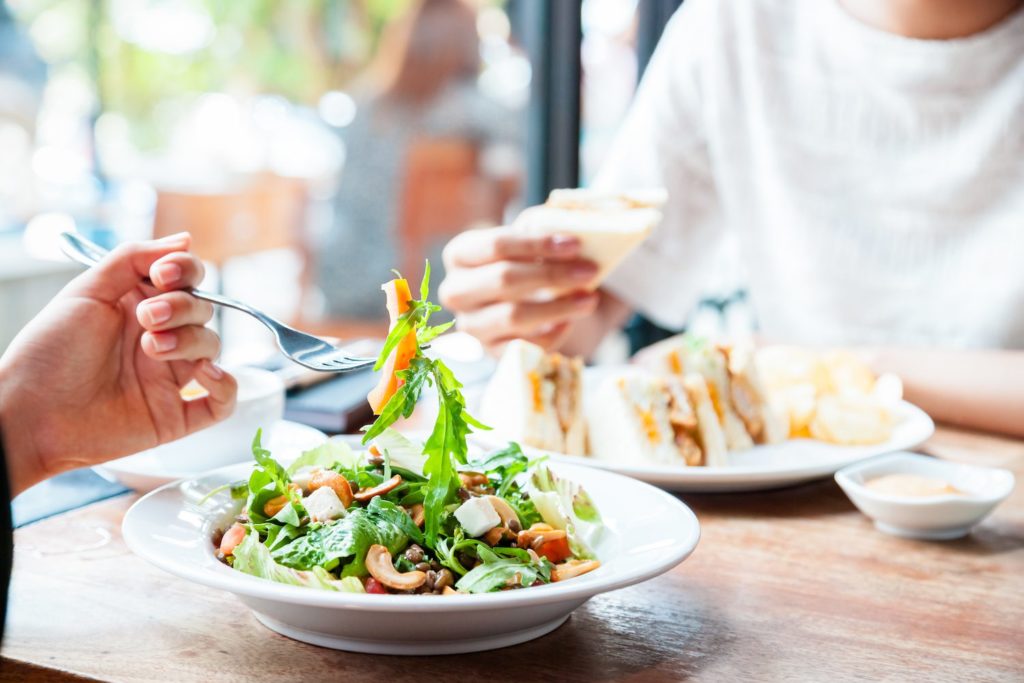 Here’s Why You Get Sleepy After Eating Two people eating a meal