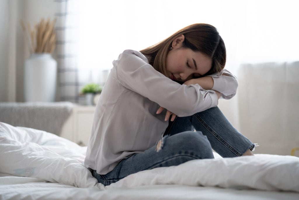 What Causes Insomnia? Woman in bed unable to sleep